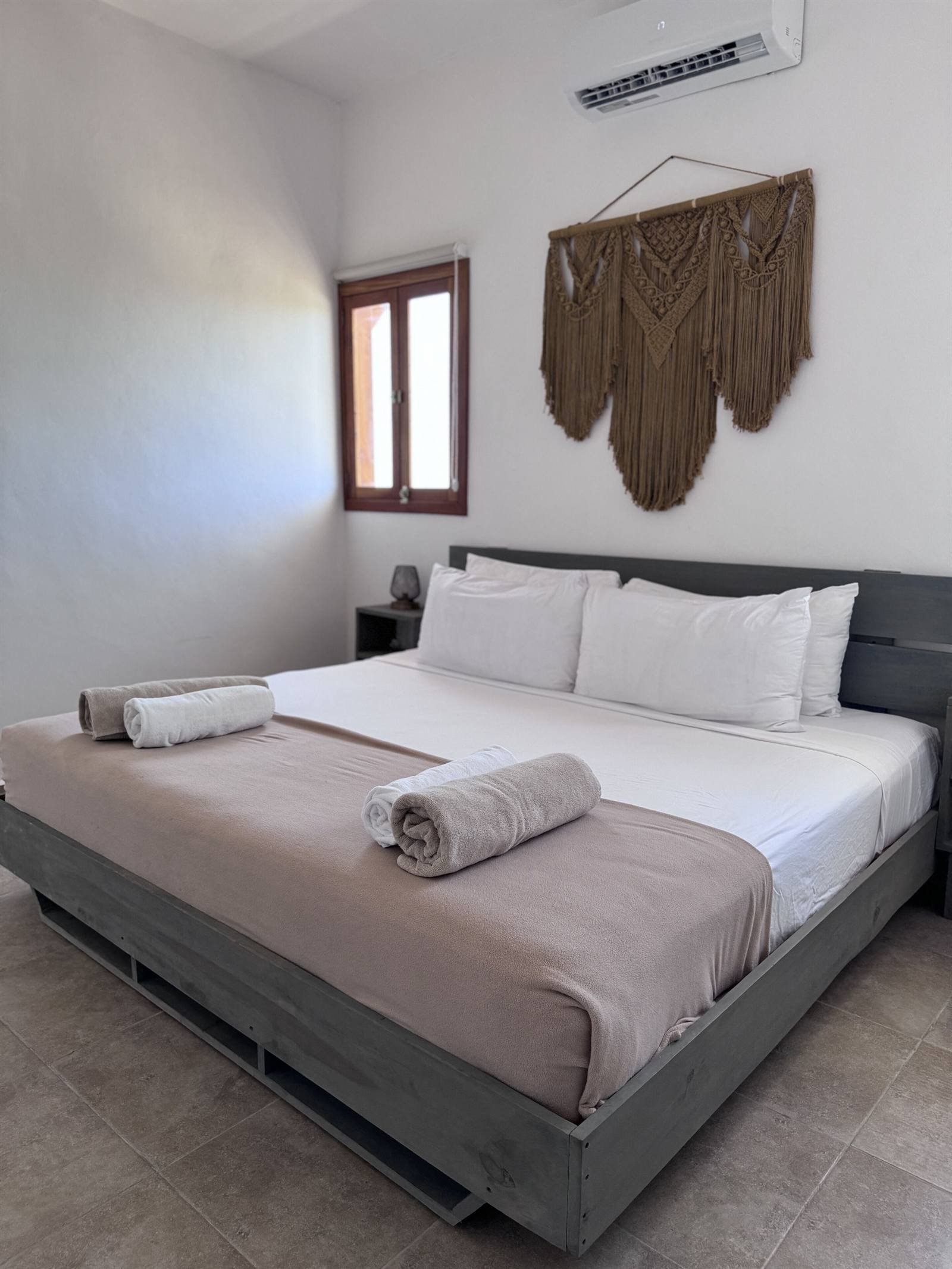 La Casa del Sol Holbox: room with a King bed and macramé wall hanging